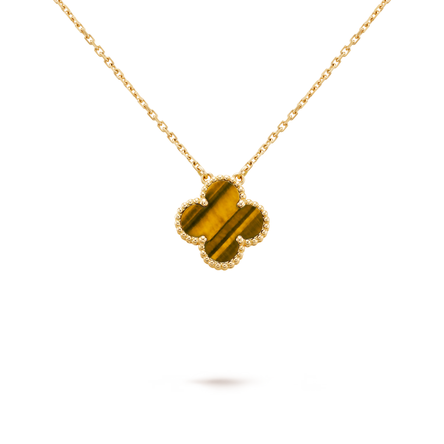 Gold necklace with a clover-shaped pendant on a black background