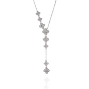 Close-up of silver Clover Drop necklace with cascading clover motifs set in pavé moissanite