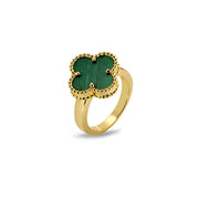 Angled view of clover-shaped ring with green inlay and textured beaded gold frame