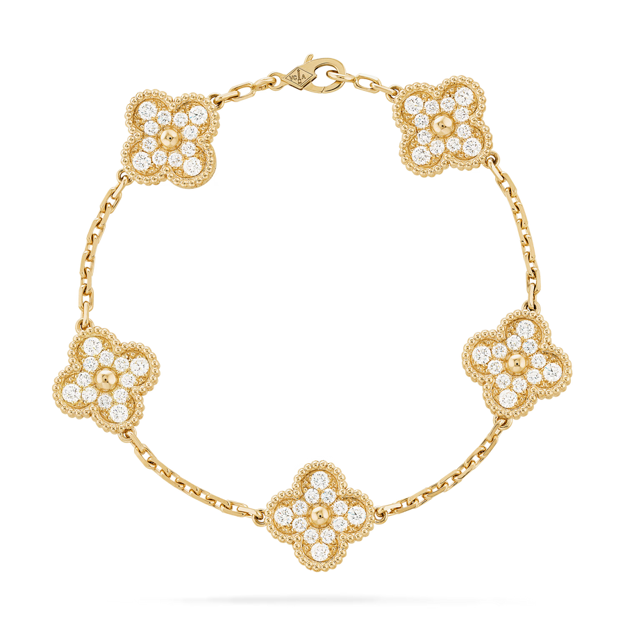 Gold bracelet with floral designs and clear stones on a black background