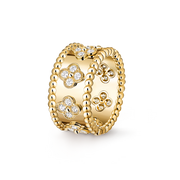 Gold ring with floral designs and clear stones on a white background