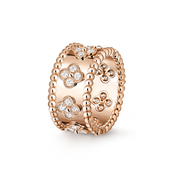 Rose gold ring with floral designs and clear stones on a white background