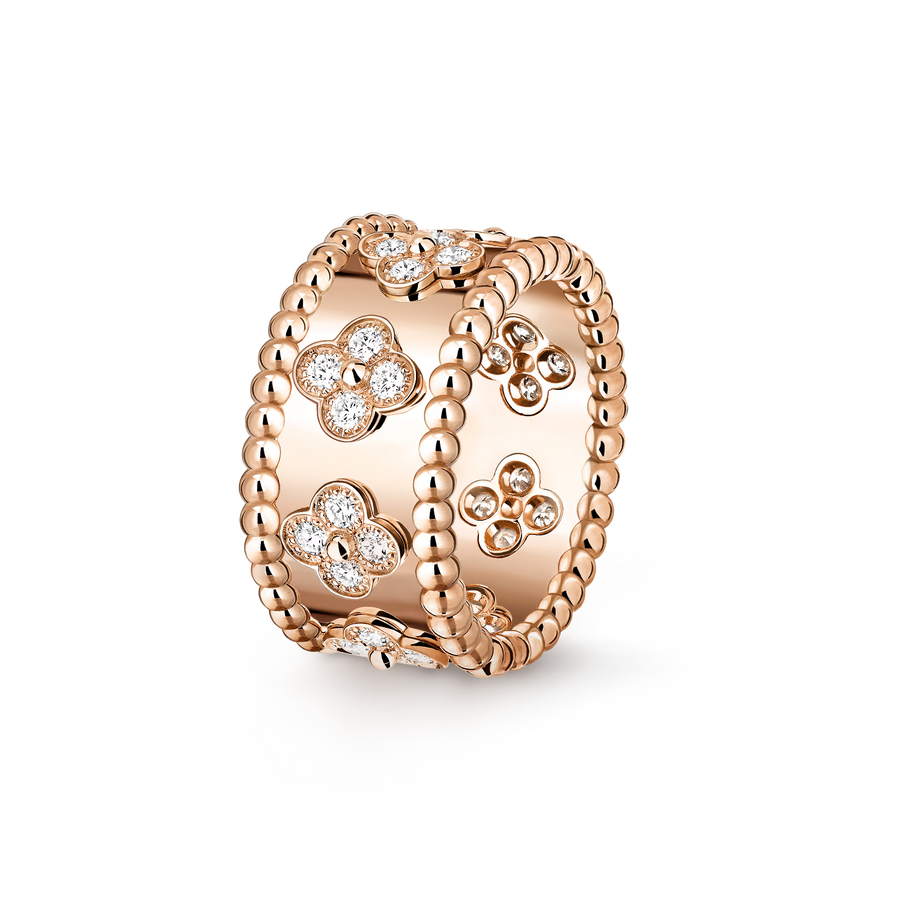 Rose gold ring with floral designs and clear stones on a white background