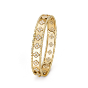 Gold bracelet with floral designs on a black background