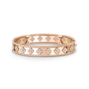 Rose gold bracelet with floral designs on a black background
