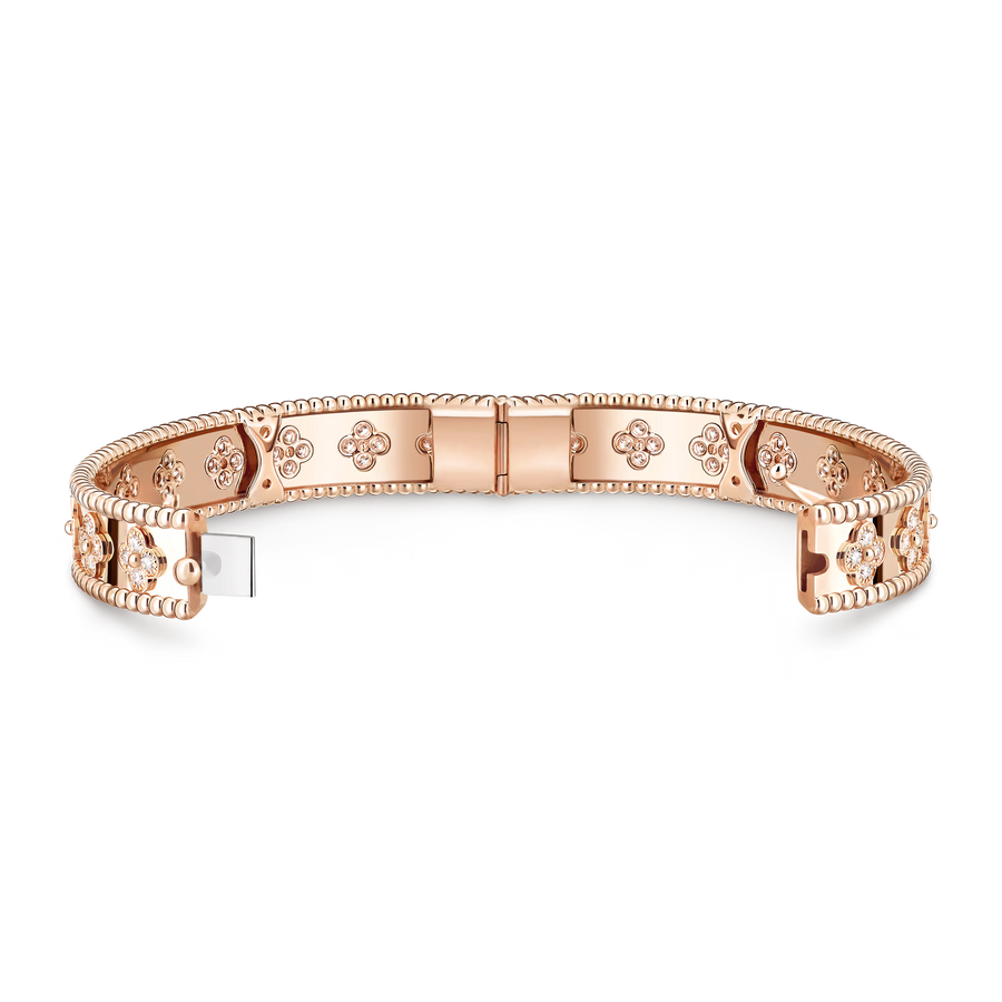 Rose gold bracelet with intricate designs on a white background