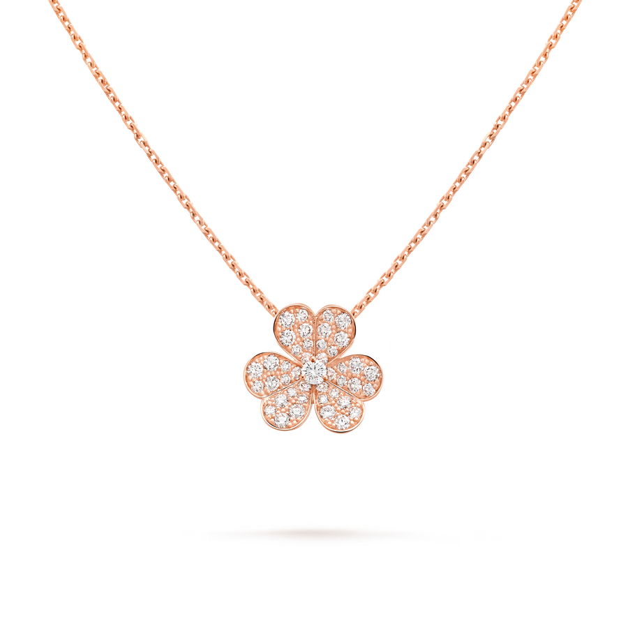 Rose gold necklace with a clover-shaped pendant on a black background
