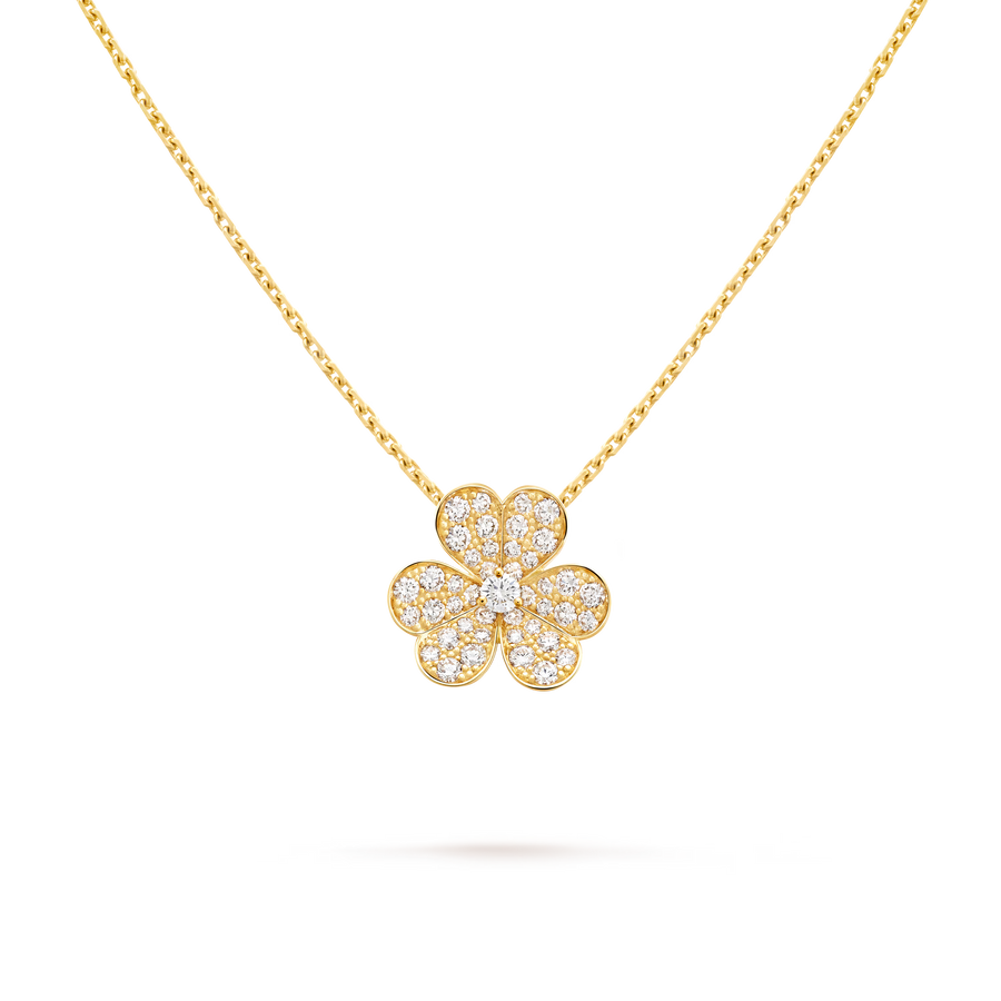 Gold necklace with a clover-shaped pendant on a black background