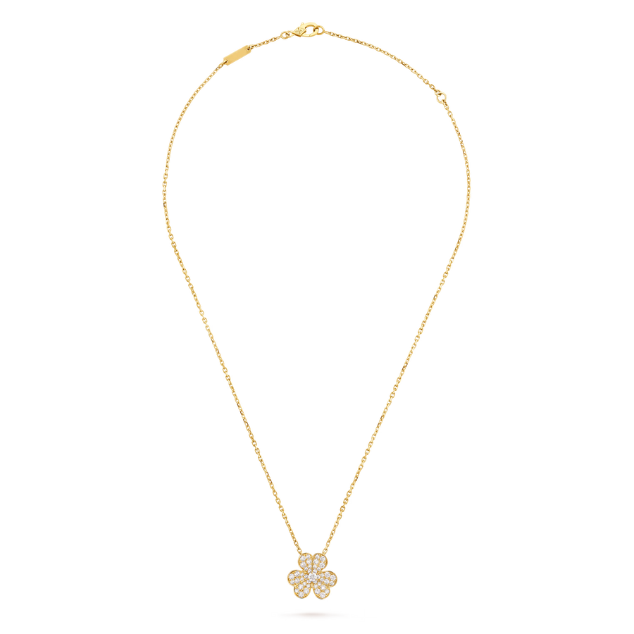 Gold necklace with a floral pendant on a black background