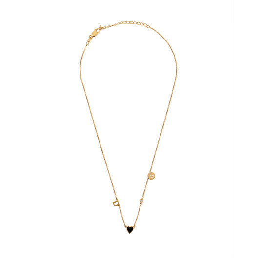 Full-length view of gold necklace with black heart charm, initial, and small decorative accents