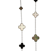 Close-up of Long Clover necklace showing beaded clover charms in black, white, and green inlay with silver chain links