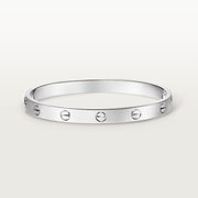Silver bracelet with circular design on a white background