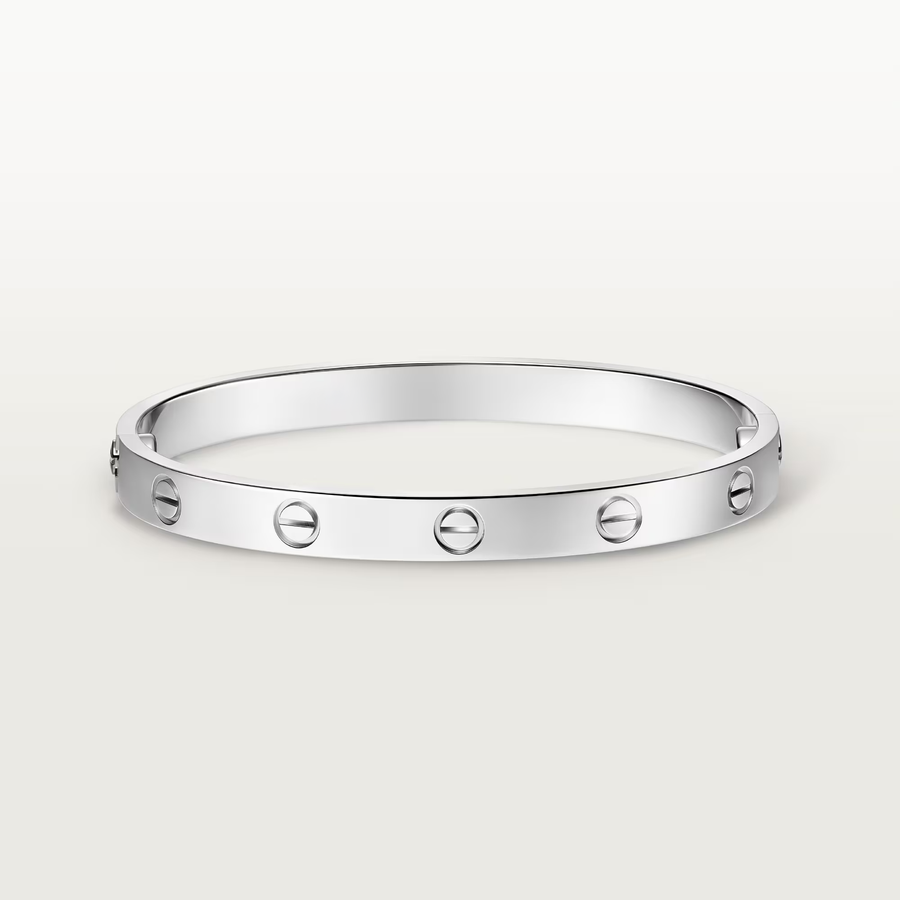 Silver bracelet with circular design on a white background