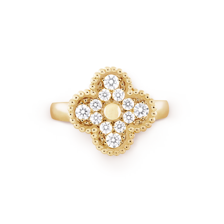 Gold ring with diamond accents on a black background