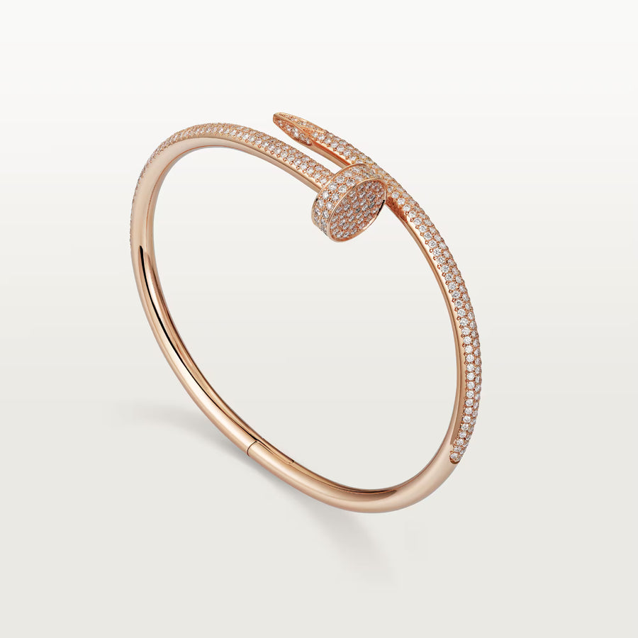 Rose gold bracelet with diamond accents on a light gray background