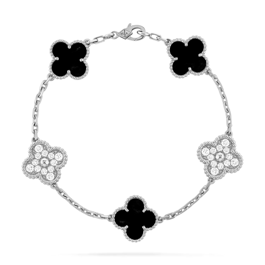 Overhead view of bracelet with alternating moissanite pavé and black onyx clover charms