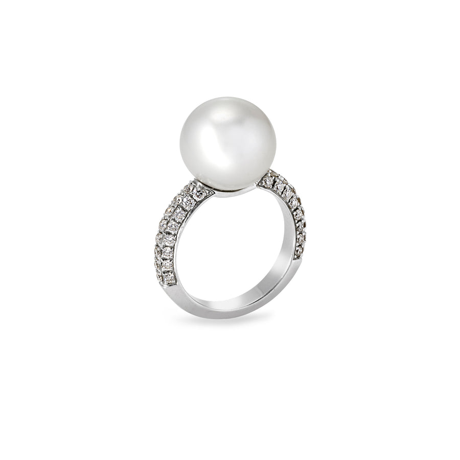 Angled view of pearl solitaire ring with moissanite pavé detailing along the band
