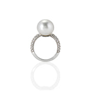 Side view of Solitaire ring featuring a large pearl centre and pavé-set moissanite band in polished silver finish