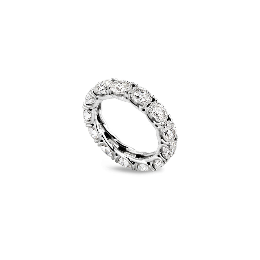 Angled view of full eternity ring with oval-cut moissanite stones in a scalloped basket setting