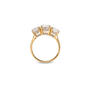 Side profile of three-stone ring with detailed pavé accent beneath each moissanite stone