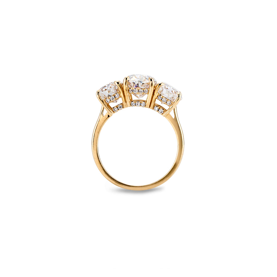 Side profile of three-stone ring with detailed pavé accent beneath each moissanite stone