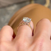 Side view of The Brittany ring showing round cut Moissanite and gold band