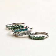 Flat lay of coloured Moissanite rings – full colour range display