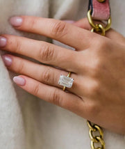 Faith ring worn on finger – elongated emerald centre stone