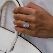 Close-up of Jean emerald cut moissanite ring worn on hand