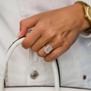 Jean ring worn on hand holding white handbag – 10ct emerald moissanite