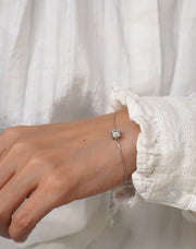 Styling shot of the 1ct Moissanite bracelet paired with a minimal outfit.
