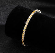 Champagne tennis bracelet displayed on velvet roll