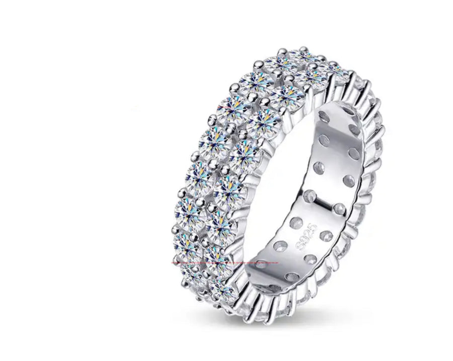 A Dior branded wedding band or statement ring with a double row pave setting and round cut diamonds.