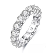 A silver-colored Moissanite stacking ring with multiple stones set around its circumference.